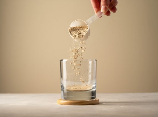 pouring-protein-powder-from-scoop-glass-glass-making-protein-drink.jpg